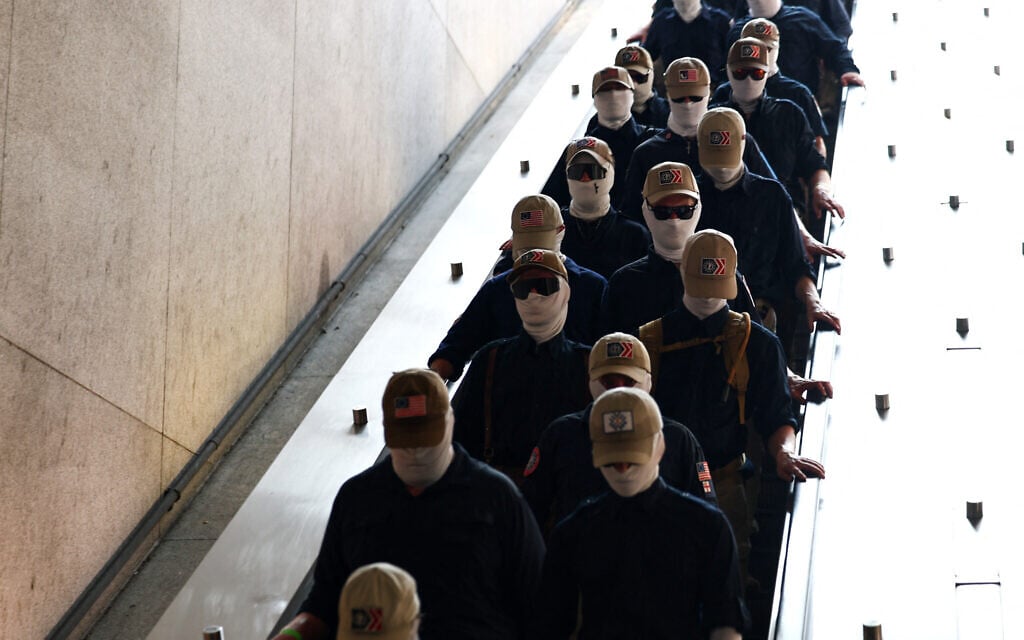 Members of the white supremacist group Patriot Front enter Eastern Market metro station on July 4, 2026 in Washington, DC. (Finn Gomez / GETTY IMAGES NORTH AMERICA / Getty Images via AFP)