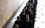 Members of the US white supremacist group Patriot Front enter Eastern Market metro station on July 4, 2026 in Washington, DC. (Finn Gomez / GETTY IMAGES NORTH AMERICA / Getty Images via AFP)