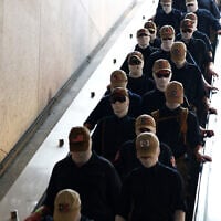 Members of the US white supremacist group Patriot Front enter Eastern Market metro station on July 4, 2026 in Washington, DC. (Finn Gomez / GETTY IMAGES NORTH AMERICA / Getty Images via AFP)