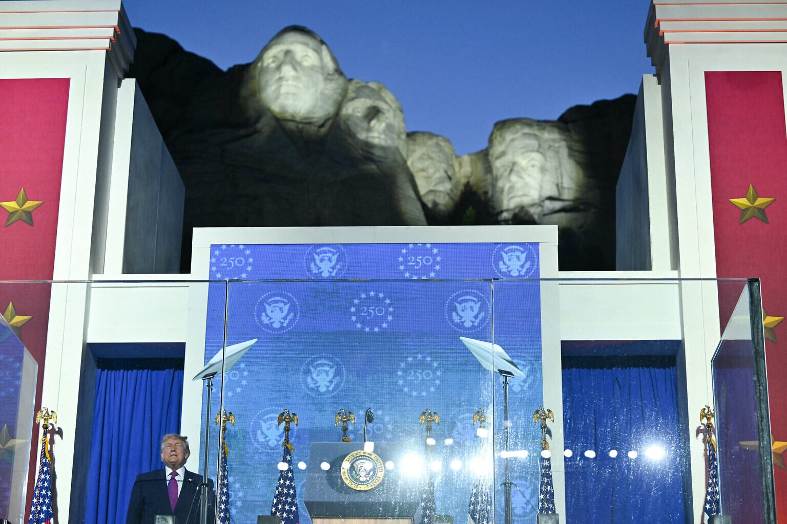 US President Donald Trump steps on stage to deliver remarks during the Independence Day events at Mount Rushmore National Memorial in Keystone, South Dakota, July 3, 2026. (Photo by Mandel NGAN / AFP) US President Donald Trump steps on stage to deliver remarks during the Independence Day events at Mount Rushmore National Memorial in Keystone, South Dakota, July 3, 2026. (Photo by Mandel NGAN / AFP)