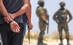 Israeli soldiers prevent Palestinian residents from the village of Qabalan, south of Nablus in the West Bank, from returning to their homes and lands after Israeli settlers, who had established an outpost on the village's land, prevented them from approaching, July 4, 2026. (Jaafar Ashtiyeh/AFP)