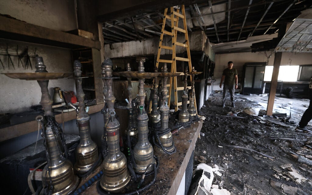 A Palestinian man inspects the aftermath at his restaurant after it was burned down by settlers during an attack in the western area of the Al-Lubban ash-Sharqiya village, south of Nablus, in the West Bank, on July 5, 2026 (JAAFAR ASHTIYEH / AFP)