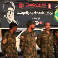 Members of Iraq’s Popular Mobilization Forces stand near a portrait of Iran’s slain supreme leader Ali Khamenei at the shrine of Imam Hussein on the eve of his funeral ceremonies in the holy Iraqi city of Karbala on July 7, 2026. (AHMAD AL-RUBAYE/AFP)