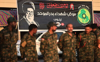 Members of Iraq’s Popular Mobilization Forces stand near a portrait of Iran’s slain supreme leader Ali Khamenei at the shrine of Imam Hussein on the eve of his funeral ceremonies in the holy Iraqi city of Karbala on July 7, 2026. (AHMAD AL-RUBAYE/AFP) Members of Iraq’s Popular Mobilization Forces stand near a portrait of Iran’s slain supreme leader Ali Khamenei at the shrine of Imam Hussein on the eve of his funeral ceremonies in the holy Iraqi city of Karbala on July 7, 2026. (AHMAD AL-RUBAYE/AFP)