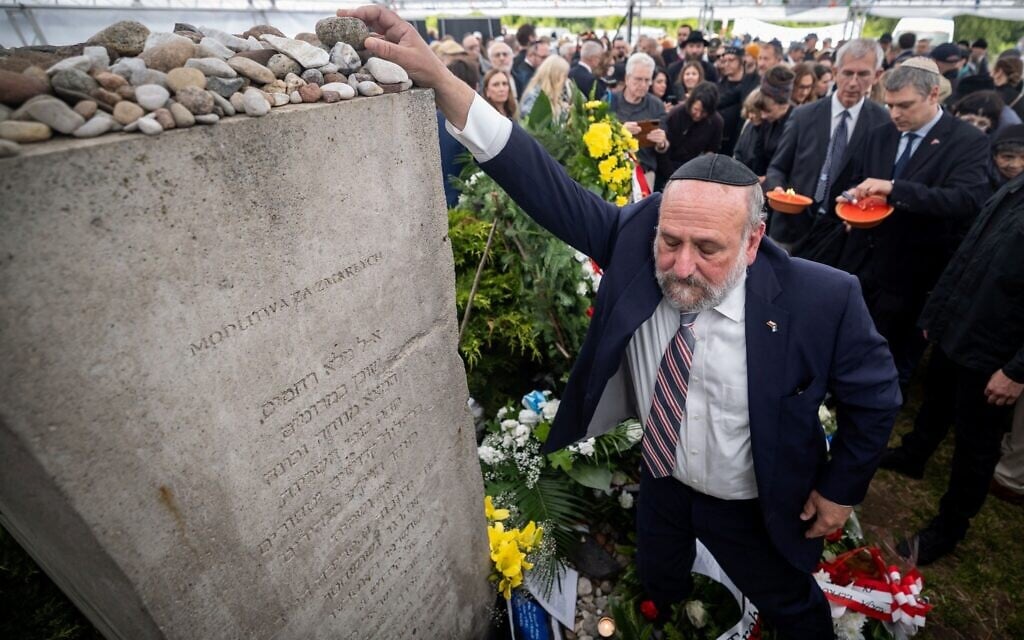 Poland's Chief Rabbi Michael Schudrich places a stone on the monument of the wartime Jedwabne massacre to honor the memory of the town's Jewish residents murdered on July 10, 1941 by their Polish neighbors, in Jedwabne, north-eastern Poland, on July 10, 2026. (Wojtek RADWANSKI / AFP) Poland's Chief Rabbi Michael Schudrich places a stone on the monument of the wartime Jedwabne massacre to honor the memory of the town's Jewish residents murdered on July 10, 1941 by their Polish neighbors, in Jedwabne, north-eastern Poland, on July 10, 2026. (Wojtek RADWANSKI / AFP)