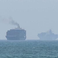 This frame grab taken from AFPTV video footage on July 12, 2026 shows cargo ships anchoring near the Strait of Hormuz off the eastern coast of the United Arab Emirates at Khor Fakkan (AFPTV/AFP)