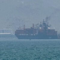 This frame grab taken from AFPTV video footage on July 12, 2026 shows a cargo ship anchoring near the Strait of Hormuz off the eastern coast of the United Arab Emirates at Khor Fakkan. (AFPTV/AFP)