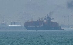 This frame grab taken from AFPTV video footage on July 12, 2026 shows a cargo ship anchoring near the Strait of Hormuz off the eastern coast of the United Arab Emirates at Khor Fakkan. (AFPTV/AFP)