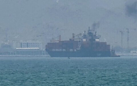 This frame grab taken from AFPTV video footage on July 12, 2026 shows a cargo ship anchoring near the Strait of Hormuz off the eastern coast of the United Arab Emirates at Khor Fakkan. (AFPTV/AFP)