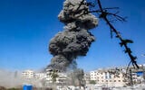 A smoke plume billows during an Israeli strike on an industrial area in Gaza City on July 12, 2026. (Omar AL-QATTAA/ AFP)
