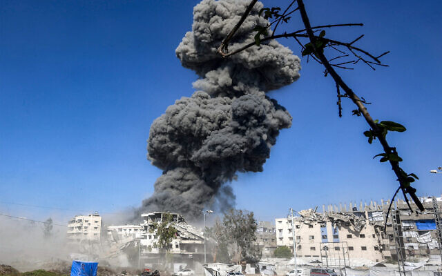 A smoke plume billows during an Israeli strike on an industrial area in Gaza City on July 12, 2026. (Omar AL-QATTAA/ AFP) A smoke plume billows during an Israeli strike on an industrial area in Gaza City on July 12, 2026. (Omar AL-QATTAA/ AFP)
