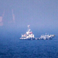 This picture shows ships sailing near the Strait of Hormuz off the eastern coast of the United Arab Emirates at Khor Fakkan on July 13, 2026 (AFP)