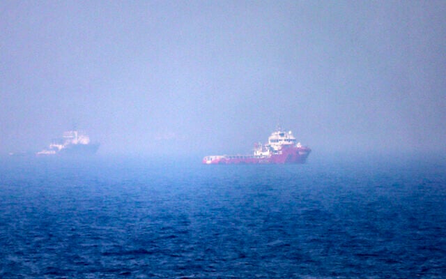 Ships sailing near the Strait of Hormuz off the eastern coast of the United Arab Emirates at Khor Fakkan on July 13, 2026 (AFP)