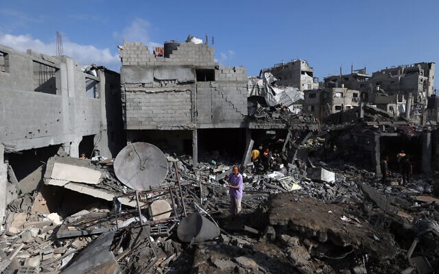 Palestinians inspect the site of an Israeli strike at the Bureij refugee camp in central Gaza Strip, on July 16, 2026 (Eyad Baba/AFP)
