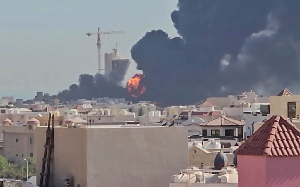 This screen grab taken from UGC video footage posted on social media on July 18, 2026, shows a plume of black smoke and flames billowing over the town of Mangaf, south of Kuwait City. (various sources/AFP)