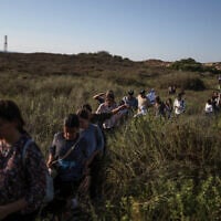 This picture taken from a position on the Israeli border with the Gaza Strip shows settler activists attempting to make their way into the Palestinian territory on July 19, 2026. (Ilia YEFIMOVICH/AFP)