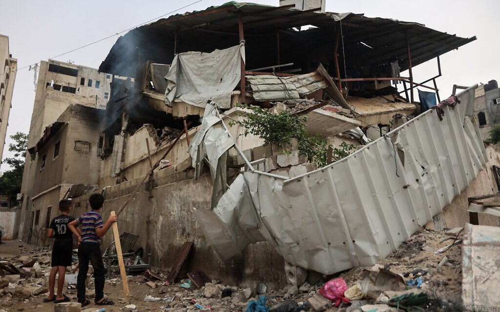 Palestinian boys look at a damanged a house after an Israeli airstrike in Gaza City on July 21, 2026. (Omar AL-QATTAA/AFP)