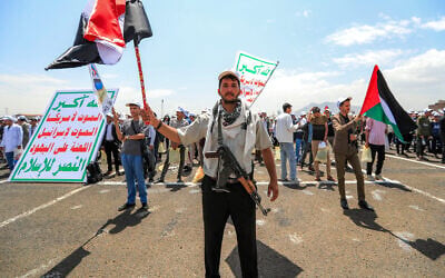 An armed student waves a Yemeni flag as he is flanked by a peer waving a Palestinian flag and others displaying the Houthi rebels' banner, which reads 'Death to America, death to Israel, a curse on the Jews,' at a rally in support of the Iran-backed rebels amid escalating tensions with Saudi Arabia, on the Sanaa University Campus in the Houthi-held Yemeni capital, on July 22, 2026. (Mohammed HUWAIS/AFP) An armed student waves a Yemeni flag as he is flanked by a peer waving a Palestinian flag and others displaying the Houthi rebels' banner, which reads 'Death to America, death to Israel, a curse on the Jews,' at a rally in support of the Iran-backed rebels amid escalating tensions with Saudi Arabia, on the Sanaa University Campus in the Houthi-held Yemeni capital, on July 22, 2026. (Mohammed HUWAIS/AFP)