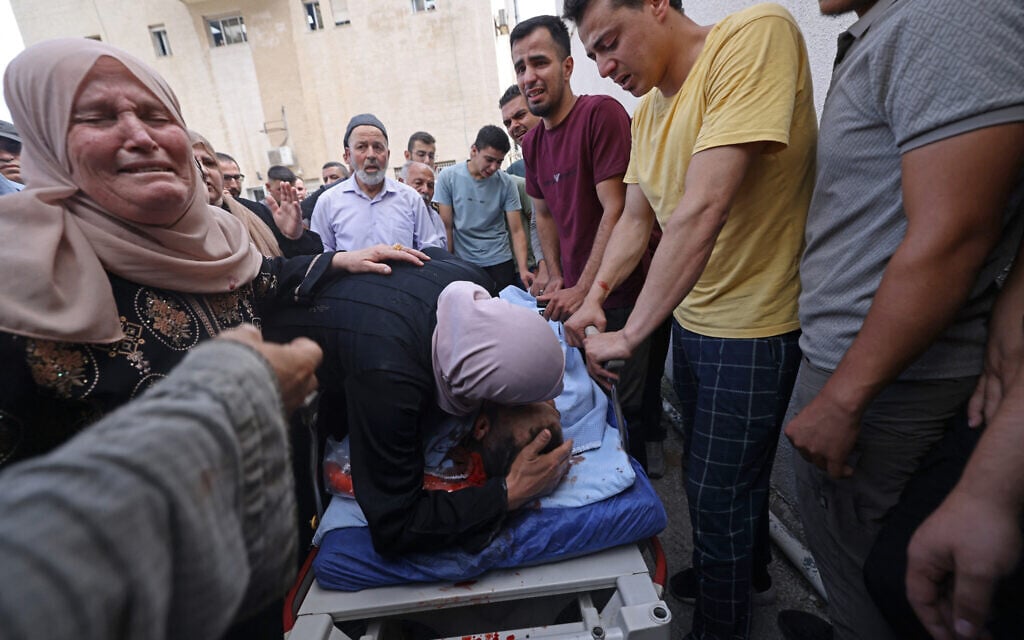 Mourners weep over the body of a Palestinian man who was killed in a shooting, at a hospital in Nablus, in the West Bank on July 24, 2026. (JAAFAR ASHTIYEH/AFP)