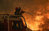 French firefighters try to extinguish a wildfire near Saumos and Sainte-Hélène, northwest of Bordeaux. (Handout/SDIS33 - Caporal-chef Damien Rembert/AFP)