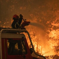 French firefighters try to extinguish a wildfire near Saumos and Sainte-Hélène, northwest of Bordeaux. (Handout/SDIS33 - Caporal-chef Damien Rembert/AFP)
