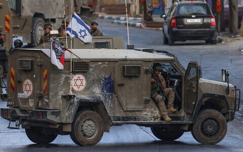 An Israeli soldier sits in his vehicle during a raid in Nablus, in the West Bank on July 26, 2026. (Zain JAAFAR/AFP)