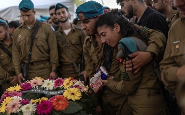 Soldiers grieve during the funeral of Maj. Yuval Ezra, 27, killed in the Palestinian West Bank, at a cemetery in Bet Dagan, central Israel on July 26, 2026. (ilia YEFIMOVICH/AFP)