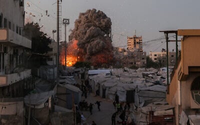 Palestinians run for cover as smoke and fire rise during an Israeli strike on the the Al-Muttaqin Mosque in Gaza City on July 28, 2026. (Omar AL-QATTAA/ AFP) Palestinians run for cover as smoke and fire rise during an Israeli strike on the the Al-Muttaqin Mosque in Gaza City on July 28, 2026. (Omar AL-QATTAA/ AFP)