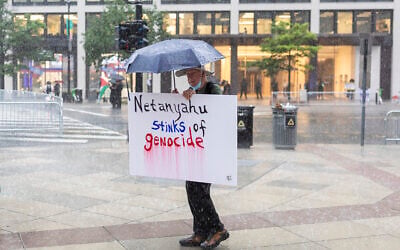 A protester stands in rain near the White House on July 28, 2026, in Washington, DC. (Finn Gomez/Getty Images/AFP)