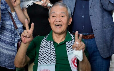 Kozo Okamoto, a member of the Japanese Red Army who carried out the May 30, 1972 attack on Lod Airport gives the victory sign to supporters as he arrives at a Palestinian cemetery to mark 50 years since the attack, in Beirut, Lebanon, May 30, 2022. (AP Photo/Hassan Ammar) Kozo Okamoto, a member of the Japanese Red Army who carried out the May 30, 1972 attack on Lod Airport gives the victory sign to supporters as he arrives at a Palestinian cemetery to mark 50 years since the attack, in Beirut, Lebanon, May 30, 2022. (AP Photo/Hassan Ammar)