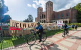 UCLA campus police cycle around the perimeter of a pro-Palestinian encampment on the UCLA campus April 26, 2024, in Los Angeles. (AP Photo/Damian Dovarganes)