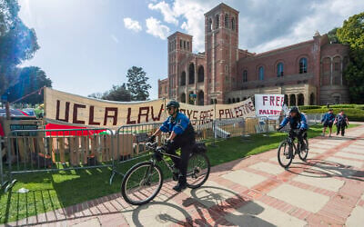 UCLA campus police cycle around the perimeter of a pro-Palestinian encampment on the UCLA campus April 26, 2024, in Los Angeles. (AP Photo/Damian Dovarganes) UCLA campus police cycle around the perimeter of a pro-Palestinian encampment on the UCLA campus April 26, 2024, in Los Angeles. (AP Photo/Damian Dovarganes)
