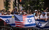 People holding Israeli and American flags gather for the annual Israel Day Parade on Fifth Avenue on June 2, 2024, in New York (AP Photo/Yuki Iwamura)