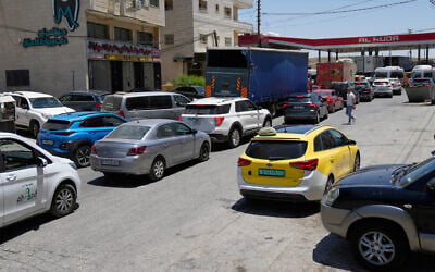 Palestinian motorists queue at a gas station while the city is experiencing a severe fuel shortage following the Israel Iran conflict, in Ramallah June 19, 2025. (AP Photo/Nasser Nasser)
