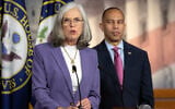 US House Minority Whip Katherine Clark speaks as House Minority Leader Hakeem Jeffries listens during a press conference on Capitol Hill on October 1, 2025, in Washington (AP Photo/Mark Schiefelbein)
