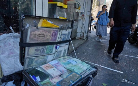 Current and pre-revolution Iranian banknotes are displayed by a street money exchanger at Ferdowsi square, Tehran’s go-to venue for foreign currency exchange, in downtown Tehran, Iran, on August 28, 2025. (AP Photo/Vahid Salemi)