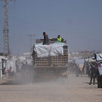 Trucks carrying food, after entering the Gaza Strip through the Kerem Shalom crossing, drive through Khan Younis, February 1, 2026. (AP Photo/Abdel Kareem Hana)