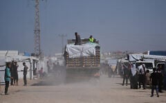 Trucks carrying food, after entering the Gaza Strip through the Kerem Shalom crossing, drive through Khan Younis, February 1, 2026. (AP Photo/Abdel Kareem Hana)