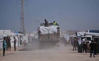 Trucks carrying food, after entering the Gaza Strip through the Kerem Shalom crossing, drive through Khan Younis, February 1, 2026. (AP Photo/Abdel Kareem Hana)