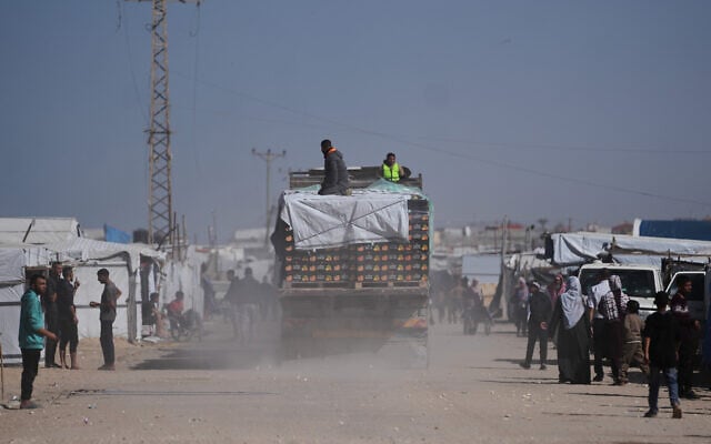Trucks carrying food, after entering the Gaza Strip through the Kerem Shalom crossing, drive through Khan Younis, February 1, 2026. (AP Photo/Abdel Kareem Hana)