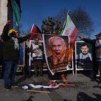 People burn an image of Prime Minister Benjamin Netanyahu during a protest against Israel and the US, in Istanbul, March 13, 2026. (AP Photo/Francisco Seco)