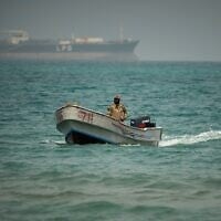Backdropped by an LPG (liquefied petroleum gas) tanker, a Yemeni soldier sails in waters north of the Bab el-Mandeb Strait in Mokha, Yemen, April 6, 2026 (AP Photo/Abdulnasser Alseddik)
