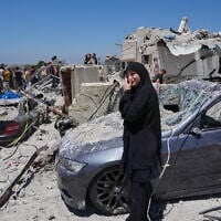 A relative of a missing victim, weeps at the site of destroyed buildings that were hit in an Israeli airstrike in Qannarit village, southern Lebanon, June 20, 2026. (AP Photo/Mohammed Zaatari)