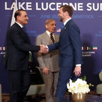 US Vice President JD Vance, right, shakes hands with Pakistan's Chief of Army Staff Field Marshal Asim Munir, left, next to Pakistan's Prime Minister Shehbaz Sharif, center, as they meet for high-level talks at the Buergenstock Resort Lake Lucerne, near Stansstad, Switzerland, Sunday, June 21, 2026. (Nathan Howard/Pool Photo via AP)