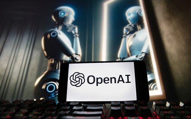 The OpenAI logo is displayed on a cellphone with an image on a computer monitor generated by ChatGPT’s Dall-E text-to-image model, December 8, 2023, in Boston. (AP Photo/Michael Dwyer) The OpenAI logo is displayed on a cellphone with an image on a computer monitor generated by ChatGPT’s Dall-E text-to-image model, December 8, 2023, in Boston. (AP Photo/Michael Dwyer)