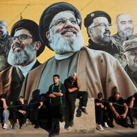 Hezbollah supporters sit in front of a giant billboard, that shows the two late leaders Hassan Nasrallah and Hashem Safieddine, center, with other Hezbollah killed commanders, as they listen to the death story of Imam Hussein during the holy day of Ashoura in Dahiyeh, Beirut’s southern suburbs, Lebanon, June 26, 2026. (AP/Hussein Malla)
