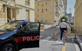 A police officer guards in a street in Monaco, on June 30, 2026, a day after an explosive device seriously injured three people at a residential building there. (AP Photo/Philippe Magoni)