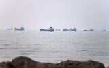 Commercial vessels are seen in the Strait of Hormuz off Bandar Abbas, Iran, June 30, 2026. (Amirhosein Khorgooi/ISNA via AP)