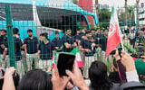 Fans greet members of the Iran World Cup soccer team as they leave their hotel for the airport, June 30, 2026, in Tijuana, Mexico. (AP Photo/Gregory Bull)