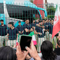 Fans greet members of the Iran World Cup soccer team as they leave their hotel for the airport, June 30, 2026, in Tijuana, Mexico. (AP Photo/Gregory Bull)